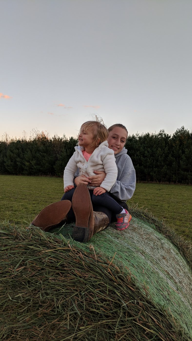 Sofie and Annika together on a hay bale when they were younger